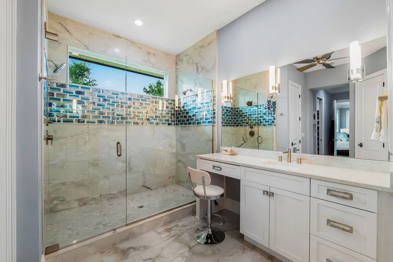 Modern bathroom with glass shower and vanity.