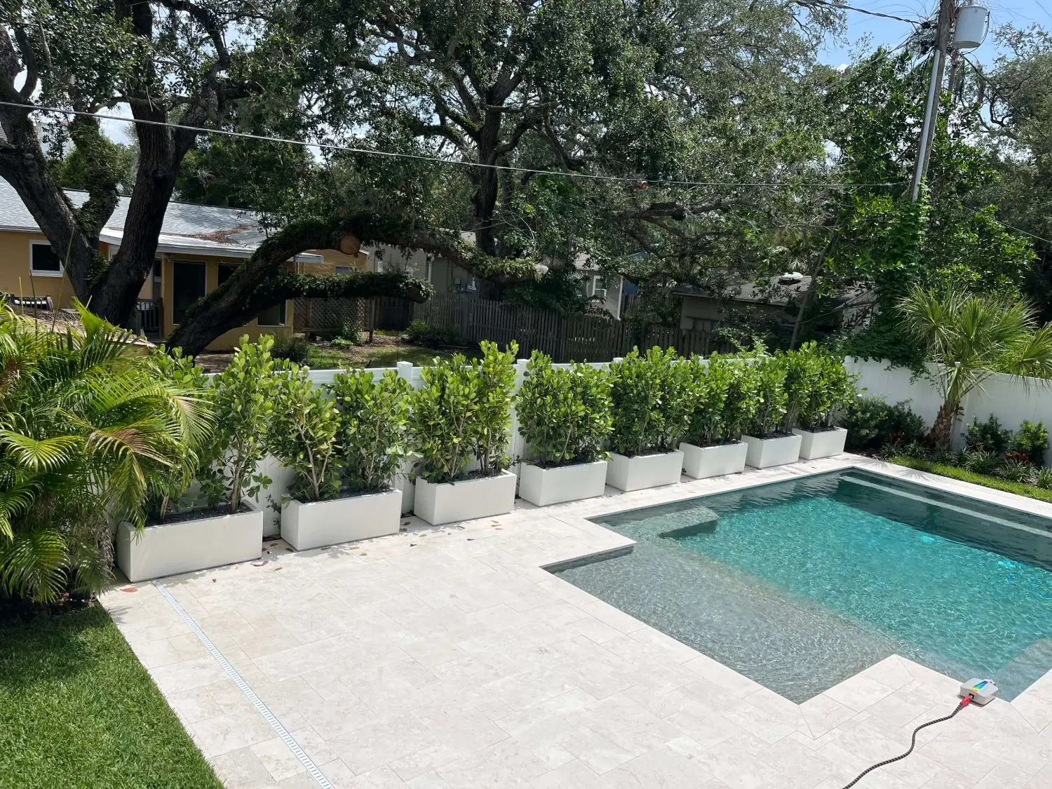 Pool deck with white rectangular planters